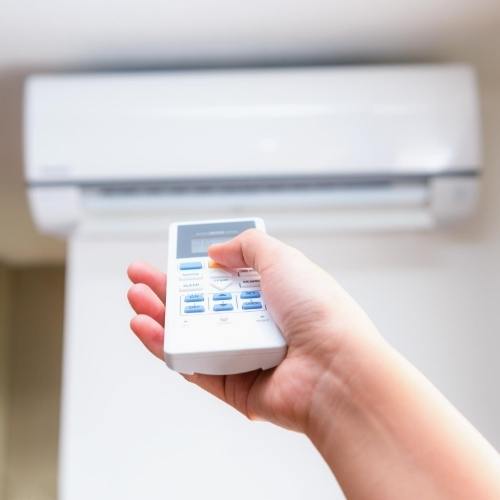 Hand pointing at air conditioner